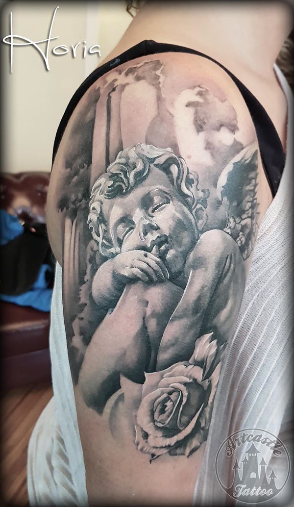 ArtCastleTattoo Tattoo ArtiestHoria Realistic black n grey angel cherub on arm with rose tattoo upper arm Black n Grey