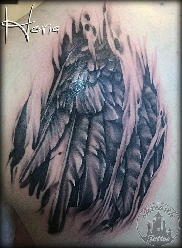 ArtCastleTattoo Tattoo ArtiestHoria Realistic torn flesh tattoo with a realistic wing and feathers black n grey Black n Grey