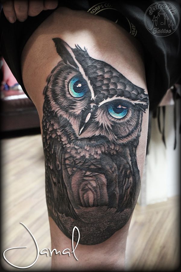 ArtCastleTattoo Tattoo ArtiestJamal Owl with forest scene inside tattoo bright blue eyes on upper leg Black n Grey
