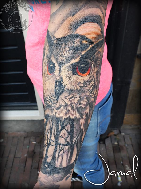 ArtCastleTattoo Tattoo ArtiestJamal Realistic owl and forest with color eyes tattoo lower arm Black n Grey
