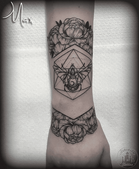 ArtCastleTattoo Tattoo ArtiestMax Blackwork beetle with geometric design and flowers on lower arm Black n Grey
