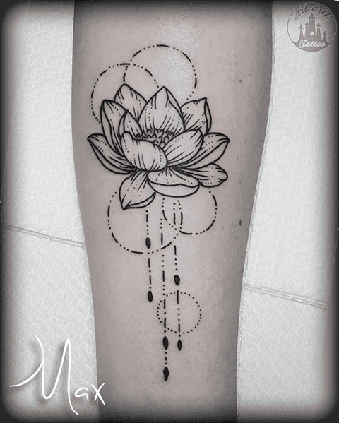 ArtCastleTattoo Tattoo ArtiestMax Tight linework lotus with some geometric dot circles and jewels hanging from it on the lower arm Blackwork