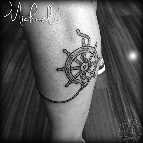 ArtCastleTattoo Tattoo ArtiestMichael Traditional ship wheel tattoo black n grey on lower leg Old School