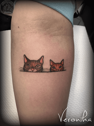 ArtCastleTattoo Tattoo ArtiestVeronika Two small cats faces peeking over a line in color Color