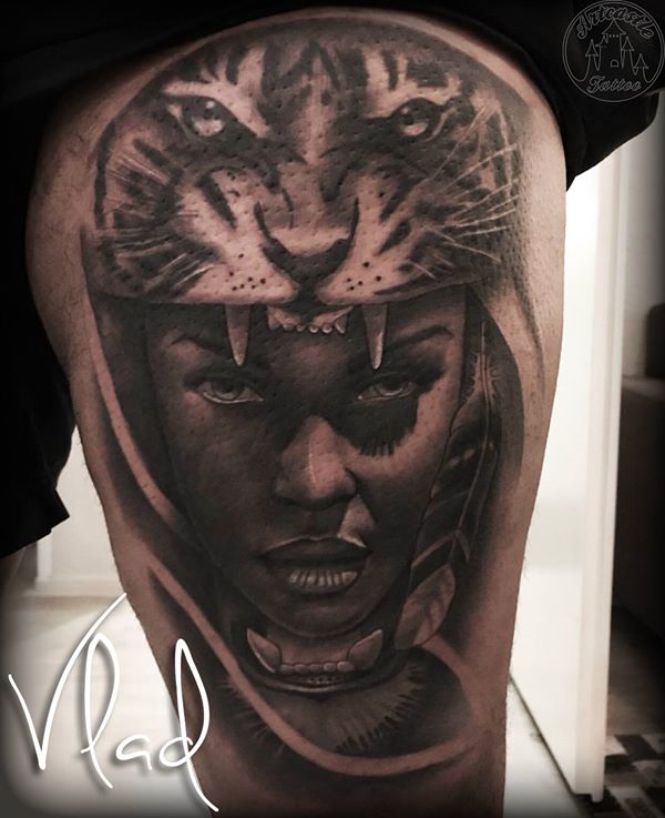 ArtCastleTattoo Tattoo ArtiestVlad Womans face portrait with tiger headdress tattoo black n grey on leg Black n Grey